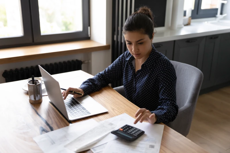 Woman at desk working on a computer with a Colorado loan officer